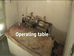 <div style = 'text-align:center;'><b>This is THE END </b></div> <BR/> This is what I saw in the dreadful autopsy center. Blood stained concrete slab for an operation table. Hammer, saw, box cutter and blood stained rocks for tools. Blood stains everywhere. Jars of body parts littered throughout. Unbearable stench.